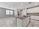 Kitchen island featuring granite counters, stainless steel sink, and white cabinets at 2456 Bagnara Pl, Henderson, NV 89044