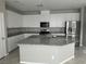 Bright kitchen featuring a large island with sink, granite countertops, and ample storage at 2456 Bagnara Pl, Henderson, NV 89044