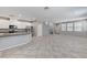 Open concept living space with tiled floor flowing into the kitchen with stainless appliances at 2456 Bagnara Pl, Henderson, NV 89044