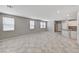 Open-concept living room with tile flooring and lots of windows for plenty of natural light at 2456 Bagnara Pl, Henderson, NV 89044