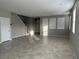 Open-concept living room features tile flooring, large windows, and neutral paint at 2456 Bagnara Pl, Henderson, NV 89044