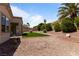 Desert backyard featuring artificial turf, gravel, mature landscaping and a covered patio at 2913 Hawksdale Dr, Las Vegas, NV 89134