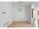 Minimalist dining room with modern chandelier, hardwood floors, and lots of natural light at 2913 Hawksdale Dr, Las Vegas, NV 89134