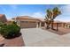 Charming desert home featuring a two-car garage, terracotta roof and manicured xeriscaping at 2913 Hawksdale Dr, Las Vegas, NV 89134
