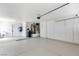 Spacious three car garage with white cabinets, storage space, and epoxy floor at 2913 Hawksdale Dr, Las Vegas, NV 89134