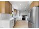 Modern kitchen with stainless steel appliances, hardwood floors, neutral cabinets and white countertops at 2913 Hawksdale Dr, Las Vegas, NV 89134