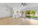 Open-concept living room and kitchen space with hardwood floors, and sliding glass doors leading to the backyard at 2913 Hawksdale Dr, Las Vegas, NV 89134
