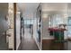 Hallway with wood floors, laundry closet, table, and mirror with a view to a dining room at 3111 Bel Air Dr # 16D, Las Vegas, NV 89109