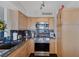 Updated kitchen featuring wood cabinetry, granite counters, and stainless steel appliances at 3111 Bel Air Dr # 16D, Las Vegas, NV 89109