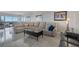 Open concept living room with marble floors, comfortable seating, and bright views from floor-to-ceiling windows at 3111 Bel Air Dr # 16D, Las Vegas, NV 89109