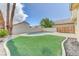Lush backyard with a kidney-shaped pool, artificial turf, and well-maintained perimeter fencing at 3743 Prairie Orchid Ave, North Las Vegas, NV 89081