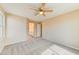 Bedroom with carpets, a fan and open entry to bath at 3743 Prairie Orchid Ave, North Las Vegas, NV 89081