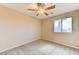Bedroom with a view featuring soft carpet, fan and a window at 3743 Prairie Orchid Ave, North Las Vegas, NV 89081