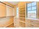 Bright walk-in closet with custom shelving and two windows provides ample storage space at 3743 Prairie Orchid Ave, North Las Vegas, NV 89081