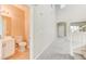 Hallway view to half bath featuring tile floors and carpet to entry at 3743 Prairie Orchid Ave, North Las Vegas, NV 89081
