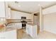 Well-lit kitchen features stainless steel appliances, granite counters, a kitchen island, and tiled floors at 3743 Prairie Orchid Ave, North Las Vegas, NV 89081
