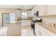 Bright kitchen featuring white cabinets, an island, granite countertops, and stainless steel appliances at 3743 Prairie Orchid Ave, North Las Vegas, NV 89081