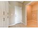 Hallway with a laundry room featuring white cabinets and tile flooring at 3743 Prairie Orchid Ave, North Las Vegas, NV 89081