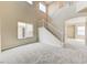 Bright living room with high ceilings, staircase, and large windows at 3743 Prairie Orchid Ave, North Las Vegas, NV 89081