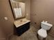 Small bathroom featuring a vanity with integrated sink, framed mirror, toilet, and tile flooring at 377 N 16Th St, Las Vegas, NV 89101