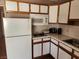 A kitchen featuring white appliances and neutral tile backsplash at 377 N 16Th St, Las Vegas, NV 89101