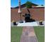 Paver walkway leads to barbecue in fenced backyard with artificial turf at 3862 E Summit Ave, Pahrump, NV 89061