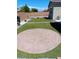Well manicured backyard features a circular paver patio and artificial turf at 3862 E Summit Ave, Pahrump, NV 89061
