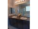 Bathroom featuring a double vanity, granite countertop, and a shower and tub at 3862 E Summit Ave, Pahrump, NV 89061