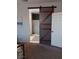 Bedroom with a barn door leading to a bathroom at 3862 E Summit Ave, Pahrump, NV 89061