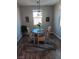 Cozy dining area with a round table, four chairs, natural light, and stylish decor at 3862 E Summit Ave, Pahrump, NV 89061