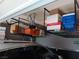 Garage featuring overhead storage racks with stored boxes above a parked vehicle at 3862 E Summit Ave, Pahrump, NV 89061