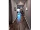 Inviting hallway featuring wood-look flooring, neutral walls, and a glimpse into the open living spaces beyond at 3862 E Summit Ave, Pahrump, NV 89061