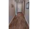 Hallway with modern wood-look flooring, neutral walls, leading to a bright white front door at 3862 E Summit Ave, Pahrump, NV 89061