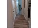 A well-lit hallway with wood-look flooring leads past a laundry room and multiple doors at 3862 E Summit Ave, Pahrump, NV 89061