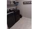 Laundry room features dark appliances, a white shelf and decorative Laundry Room sign at 3862 E Summit Ave, Pahrump, NV 89061