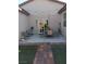 Covered patio features pavers leading to sitting area in artificial turf backyard at 3862 E Summit Ave, Pahrump, NV 89061