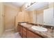 Bathroom featuring dual sinks, marble countertops, and a shower at 395 Suzanne Peak Ct, Henderson, NV 89012