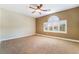 Bedroom with a ceiling fan and window with plantation shutters at 395 Suzanne Peak Ct, Henderson, NV 89012