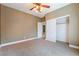 This cozy bedroom features a closet for storage and neutral colored walls at 395 Suzanne Peak Ct, Henderson, NV 89012