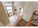 Foyer with a view of the living room with an archway, tall windows and staircase with carpeted steps at 395 Suzanne Peak Ct, Henderson, NV 89012