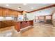 Open kitchen has granite countertops, wooden cabinets, and a central island at 395 Suzanne Peak Ct, Henderson, NV 89012