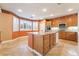 Bright kitchen featuring wood cabinets, granite countertops, island, and recessed lighting at 395 Suzanne Peak Ct, Henderson, NV 89012