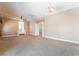 Open living room featuring carpet flooring, a hanging light fixture and multiple entries to other rooms at 395 Suzanne Peak Ct, Henderson, NV 89012