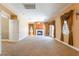 Large living room featuring carpet flooring, window treatments, a fireplace, and a hanging light fixture at 395 Suzanne Peak Ct, Henderson, NV 89012