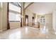 Large living room with soaring ceilings, tile flooring, and decorative chandelier creates an inviting space at 395 Suzanne Peak Ct, Henderson, NV 89012