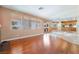 Living room shows seamless transition to kitchen, natural light and hardwood flooring at 395 Suzanne Peak Ct, Henderson, NV 89012