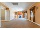 Spacious living room with carpet flooring, neutral paint, fireplace, and lots of natural light at 395 Suzanne Peak Ct, Henderson, NV 89012