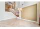 Bright, open living area with high ceilings, tile floors, and a decorative chandelier for a luxurious touch at 395 Suzanne Peak Ct, Henderson, NV 89012