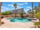 Relaxing backyard pool and spa surrounded by lush landscaping and palm trees at 395 Suzanne Peak Ct, Henderson, NV 89012