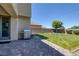 Spacious backyard with a well-maintained lawn, brick patio, and a stainless steel grill, perfect for outdoor gatherings at 4050 Midnight Crest Ave, North Las Vegas, NV 89031